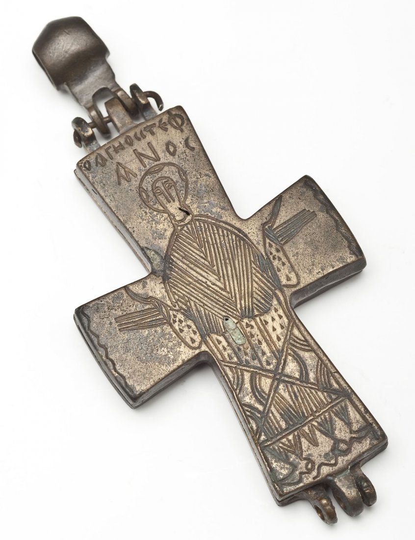 Byzantine Bronze 2 Piece Reliquary Cross: DESCRIPTION: A Byzantine bronze reliquary cross in two pieces engraved with Christ to front and figures verso. Circa 900 AD. MEASUREMENTS: 4". CONDITION: Patina and wear as expected with age.