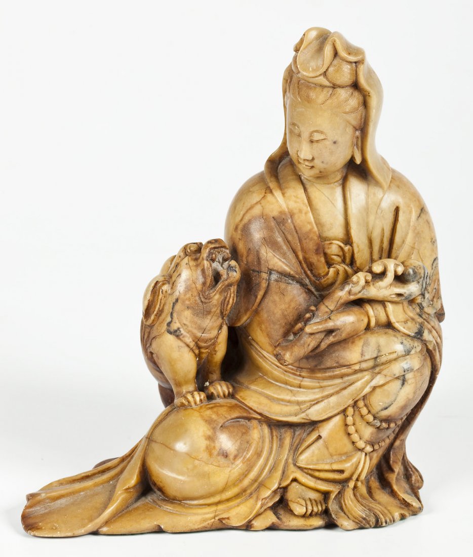 Chinese Carved Jade Quan-Yin with Foo Dog: DESCRIPTION: A Chinese carved yellow jade sculpture of a seated Quan-yin figure holding an object beside a foo dog. MEASUREMENTS: 7-5/8" x 6-1/2" x 3". CONDITION: Inherent hairlines to stone, does not