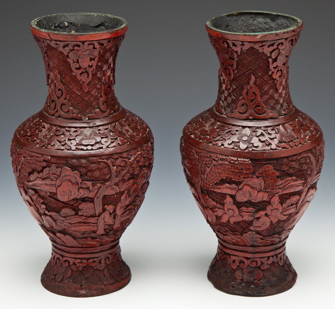Pair of Qing Dynasty Carved Cinnabar Vases: DESCRIPTION: Pair of carved cinnabar vases each depicting a landscape scene with figures around the perimeter with bands of floral and geometric decoration. Qing Dynasty. MEASUREMENTS: Each 8-3/4" x 4