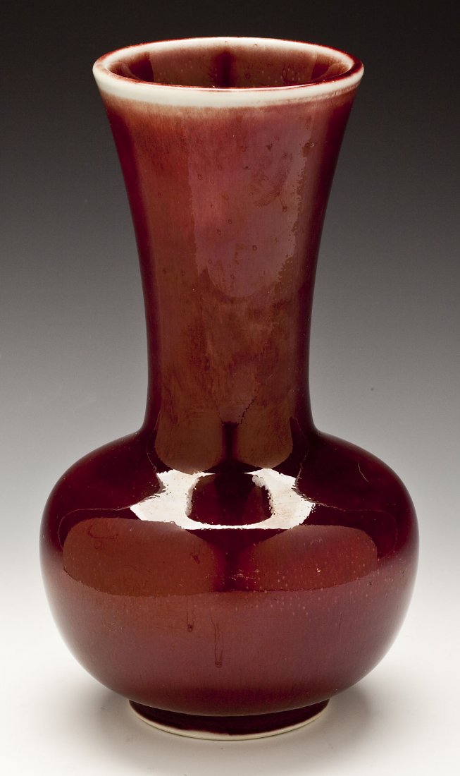 Chinese Sang de Boeuf Vase: DESCRIPTION: Chinese sang de boeuf vase. Bulbous body with long neck and flared rim. MEASUREMENTS: 9" high. CONDITION: No defects noted.
