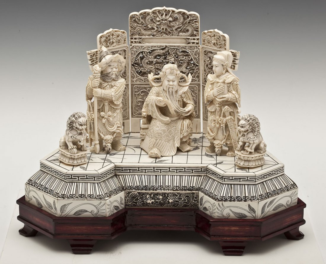 Large Chinese Carved Ivory Figural Group: DESCRIPTION: Large Chinese carved ivory figural group portraying three figures flanked by foo dogs with a rear screen. On ivory platform with wooden base. 20th century. MEASUREMENTS: 15" x 9" x 11-1/2