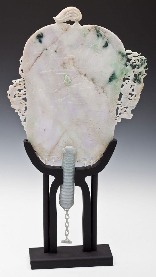 Antique Chinese Jadeite Fan: DESCRIPTION: An antique Chinese jadeite fan having a low relief carving of a mountainous landscape, reverse with calligraphy poem, and intricately carved side panels. With later custom wood stand. PRO