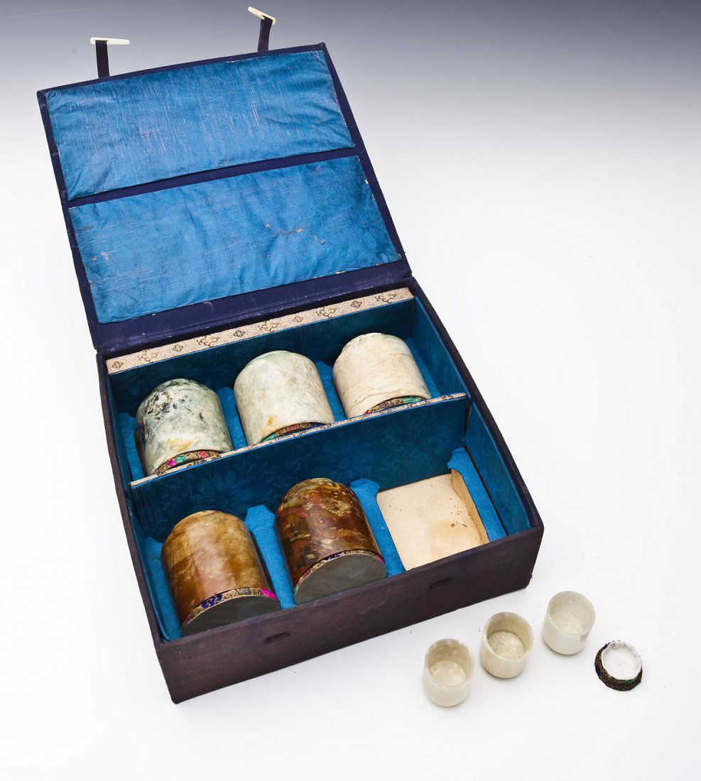 8 Chinese Bowenite Cups: DESCRIPTION: Eight Chinese bowenite cups of various colors. Columnar form on narrow footed bases. PROVENANCE: I.M. Chait Gallery, lot 1, 8/25/2002. MEASUREMENTS: Large 2-1/2" x 2-3/4". Small 1-1/4" x