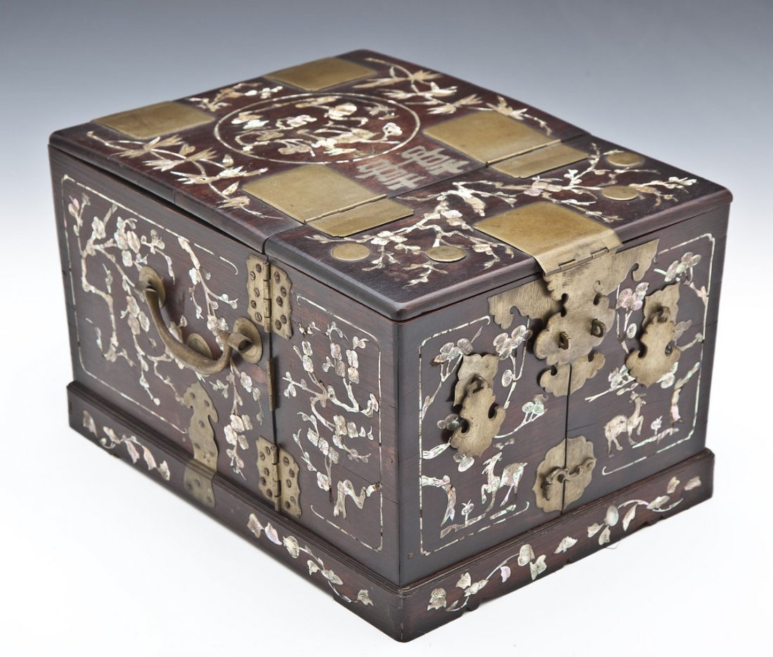 Chinese Rosewood Jewelry Box: DESCRIPTION: A Chinese jewelry box. Opens to reveal fold out mirror and various drawers. Mother of pearl inlay of animals and foliage overall. Rosewood with brass hardware. MEASUREMENTS: 10" x 13" x 8
