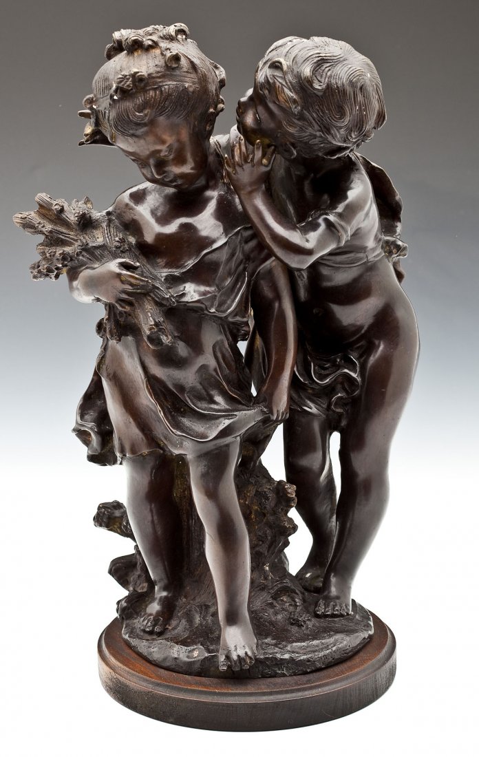 After Auguste Moreau (French, 1834-1917): DESCRIPTION: After Auguste Moreau (French, 1834-1917). A Confidence. Polychrome bronze on a circular wooden base. Signed and with worn foundry mark, on base. Depicts a boy whispering to a girl holding