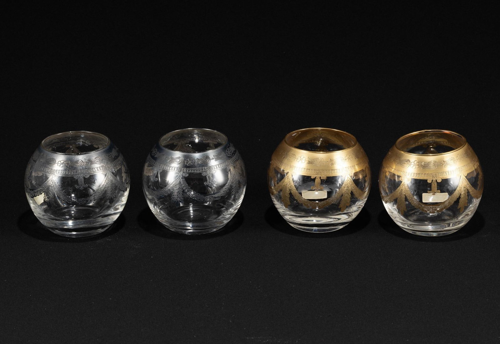 4 Pcs Neiman Marcus Glassware: Gold and silver toned decoration. Each 4-1/2" diameter x 3-3/4" high. All with some paint losses and scratches.