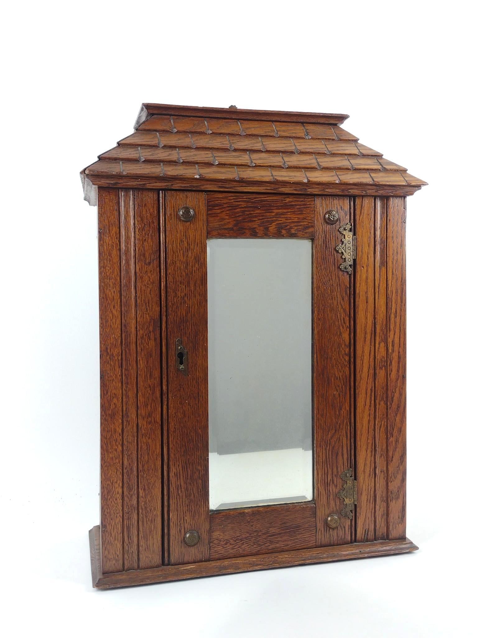 Wood House Form Wall Cabinet: NOT ELIGIBLE FOR IN-HOUSE SHIPPING. Overall with hanging bracket: 15" wide x 6-3/4" deep x 21" high. Minor wear consistent with age and use.