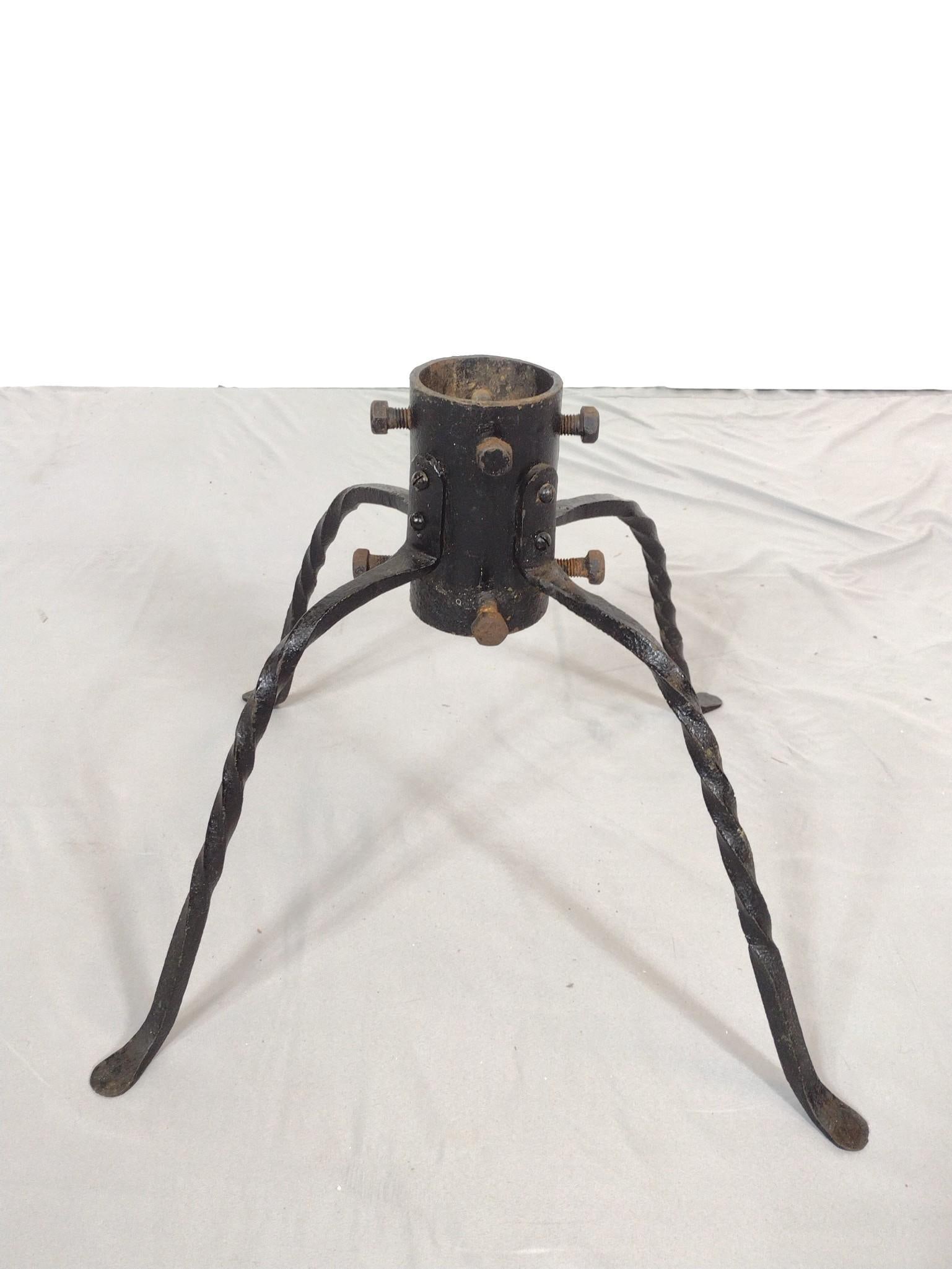 Twisted Wrought Iron Christmas Tree Stand: NOT ELIGIBLE FOR IN-HOUSE SHIPPING. 17-1/2" wide X 17-1/2" deep X 14-1/4" high. Hole diameter 3". Has some finish loss and rust.