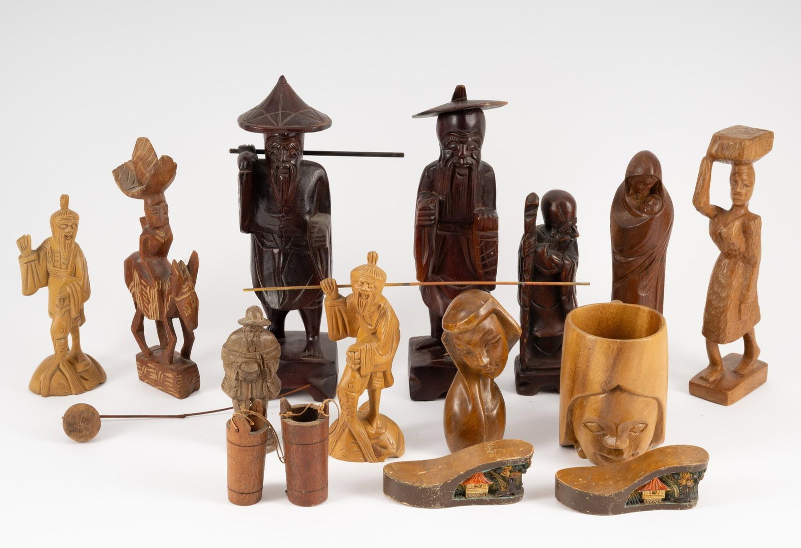 13 Wood Carvings incl Mug: Also includes shoes with landscape and figurines. 1-3/4" to 12" high. Some finish loss.