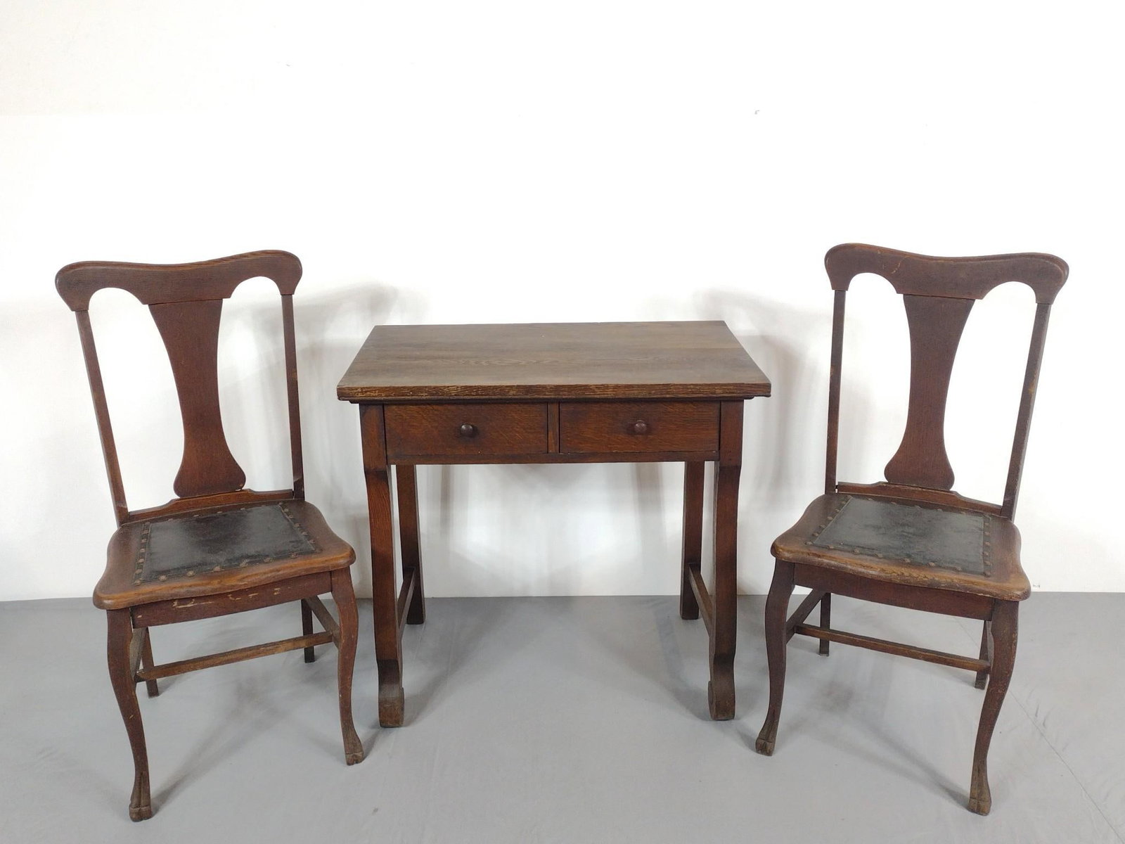 Antique Desk & Pair of Side Chairs: NOT ELIGIBLE FOR IN-HOUSE SHIPPING. Chairs with leather seat with stud boarder. Chairs: 18" wide x 16-1/2" deep x 38" high. Desk: 32" wide x 20" deep x 30" high. All with finish losses and wear consis