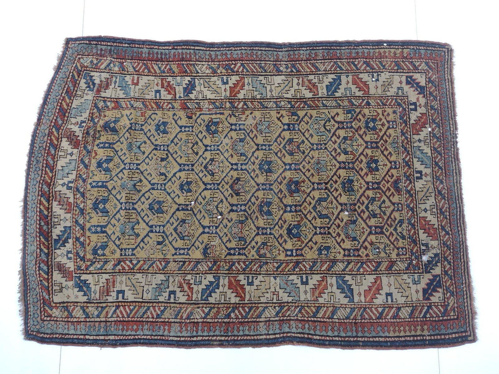 Antique Turkish Area Rug: NOT ELIGIBLE FOR IN-HOUSE SHIPPING. 3'6" wide X 4'10" long. Has some holes.