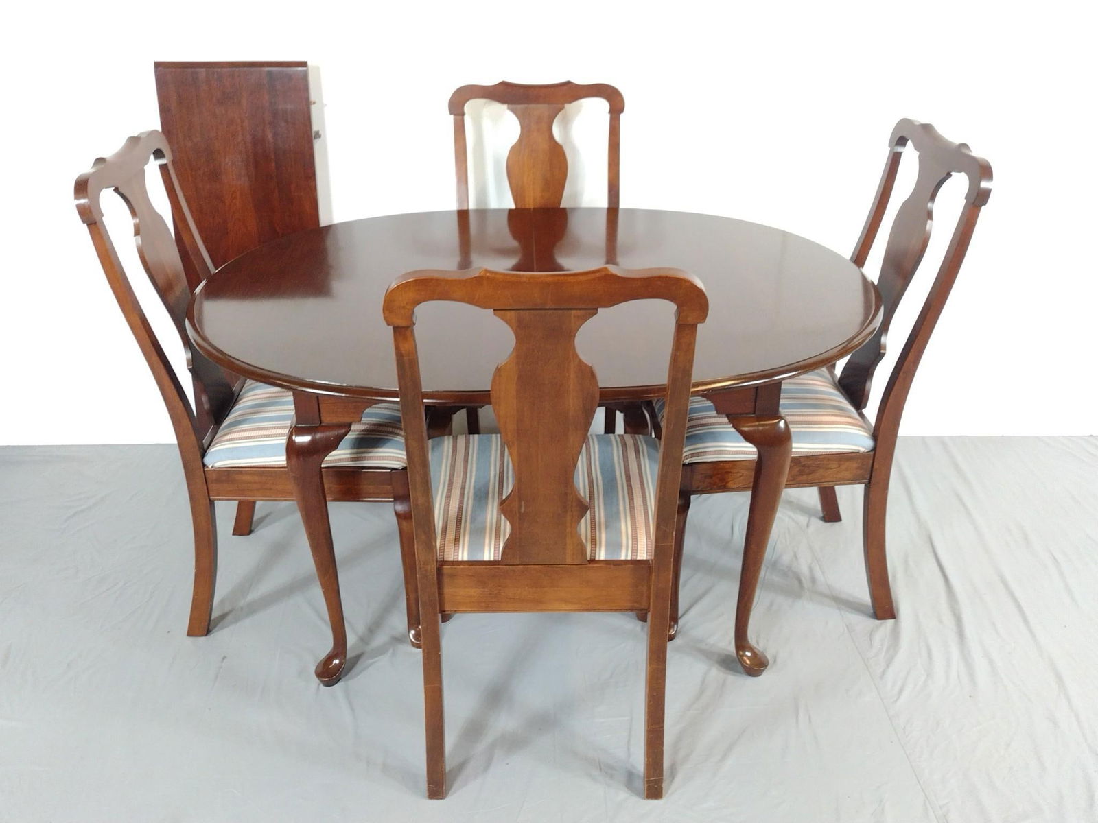 Dining Table and 4 Chairs: NOT ELIGIBLE FOR IN-HOUSE SHIPPING. Also includes 1 table leaf. Table 55" wide X 42" deep X 29" high. Table leaf 15" wide. Chairs 20-1/2" wide X 21" deep X 40" high. No manufactures name found.
