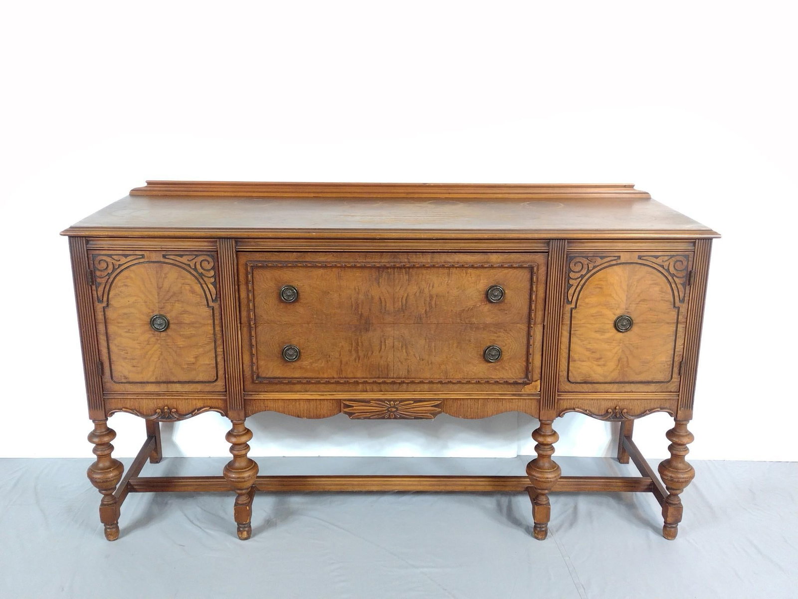 Antique Carved Sideboard: NOT ELIGIBLE FOR IN-HOUSE SHIPPING. 66" wide X 20" deep X 38-1/2" high. Has some scratches and areas of finish loss.