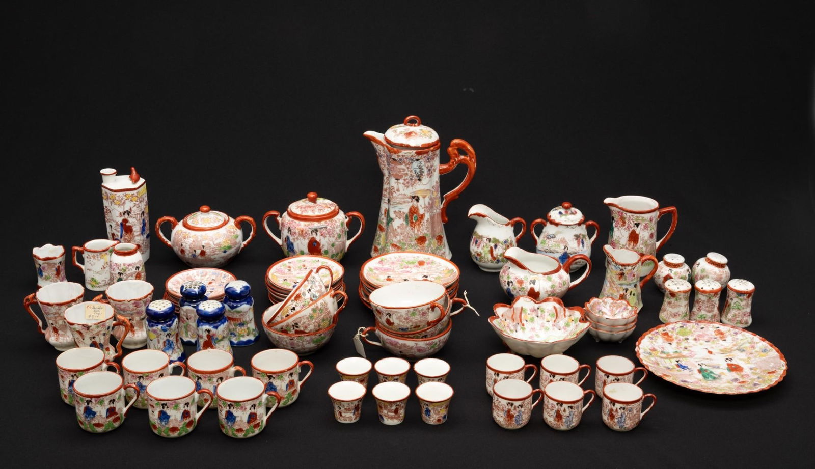 73 Pcs. Japanese Geisha Dinnerware: NOT ELIGIBLE FOR IN-HOUSE SHIPPING. Red Geisha pattern. Cups measure 1-3/4" to 3-3/4" diameter x 1-1/2" to 2" high. Tea pot measures 4-1/2" wide x 7-1/2" high.