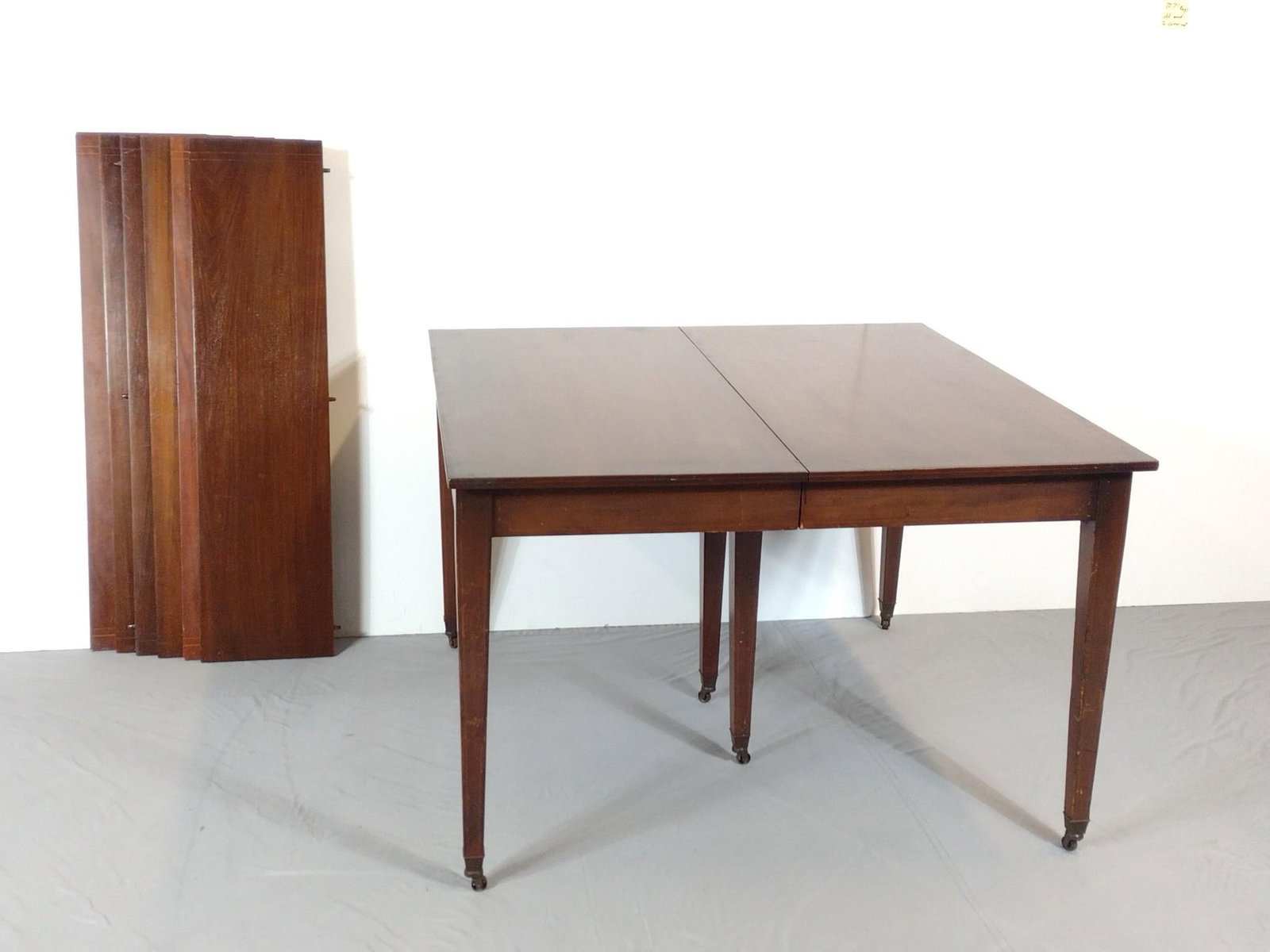 Inlaid Dining Table with 6 Leaves: NOT ELIGIBLE FOR IN-HOUSE SHIPPING. Table 47" wide X 48" deep X 30-1/2" high. Leaves 12" wide each. Table and leaves have some scratches.