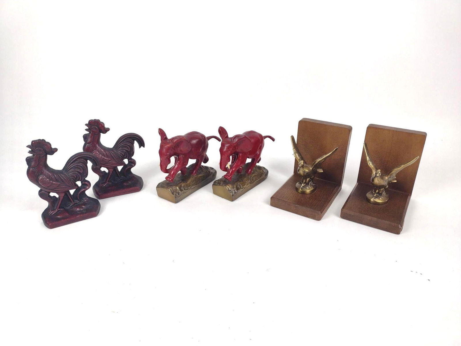 3 Pairs of Animal Bookends: Includes cast iron roosters by Virginia Metalcrafters. Some minor chips to elephants. Missing tusk. 6" to 6-3/4" high.