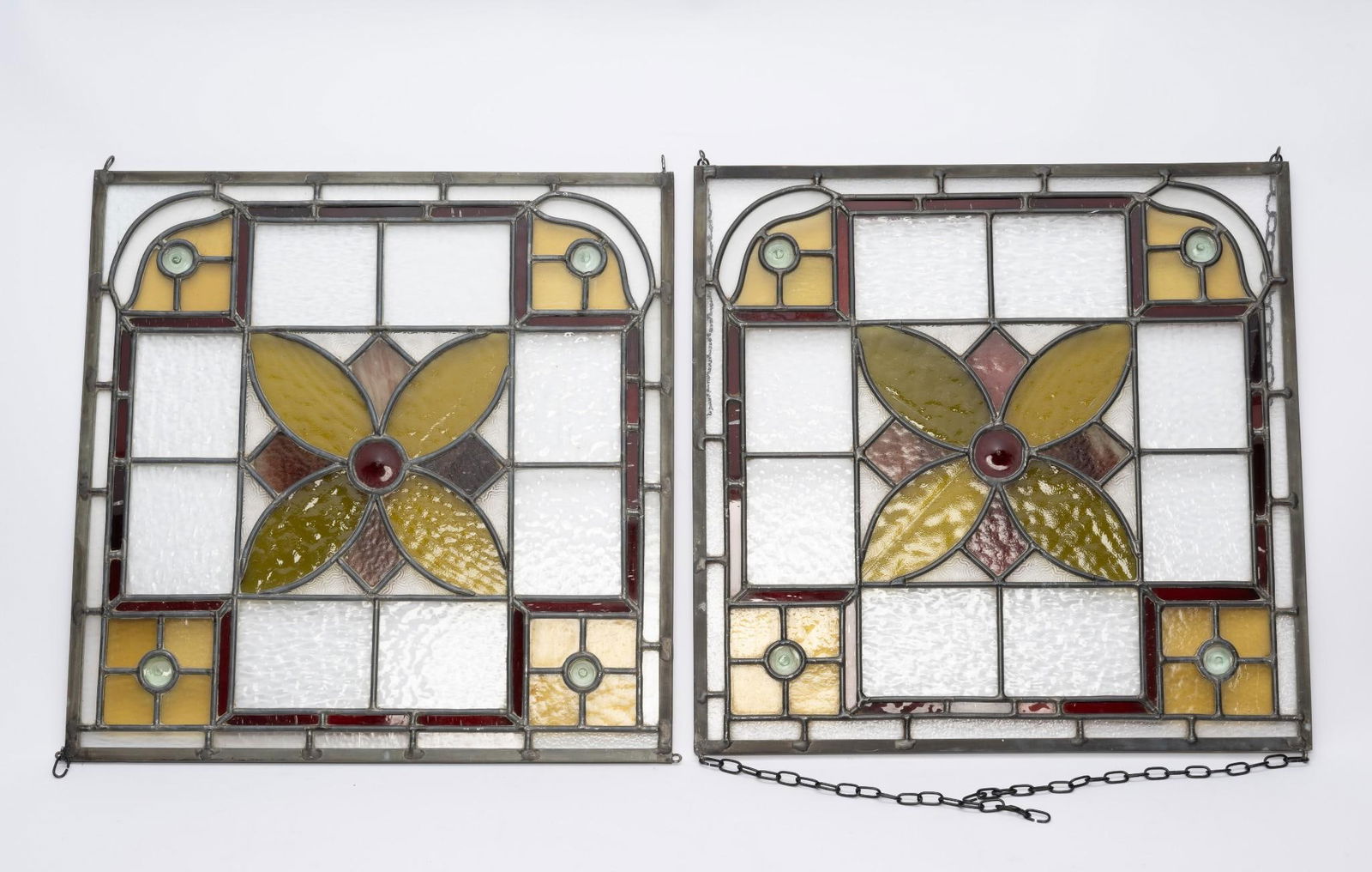 Pair of 1800’s English Pub Windows: NOT ELIGIBLE FOR IN-HOUSE SHIPPING. Leaded and stained glass panels. One missing chains. Some imperfections to glass. Each 17-1/2" square. Per consignor, windows are from England.