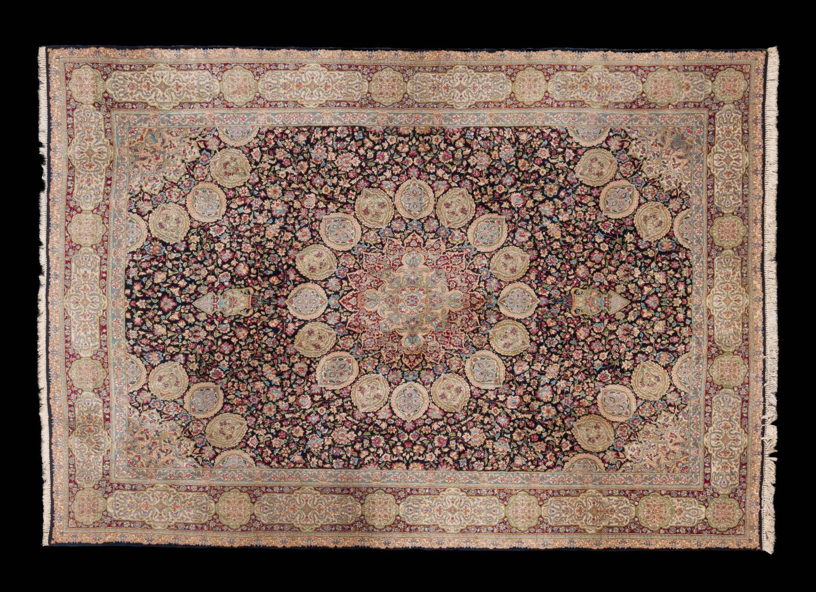 Vintage Persian Room Size Rug: NOT ELIGIBLE FOR IN-HOUSE SHIPPING. Black background with floral motifs. Floral motif around the edges. 10' 5-1/2" wide x 14' 5-1/2" long. Fading consistent with age and use.
