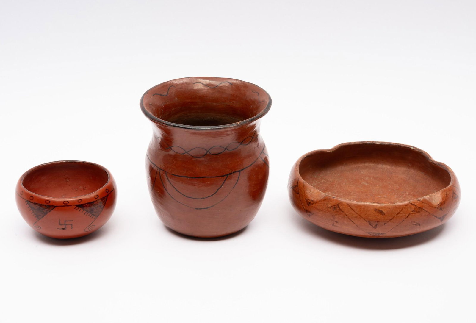 3 Hopi Pots: NOT ELIGIBLE FOR IN-HOUSE SHIPPING. Group of three Hopi pots all dating from the 1920s. None marked as was common in that period. The first a low bowl with whirling log and other motifs. The second an