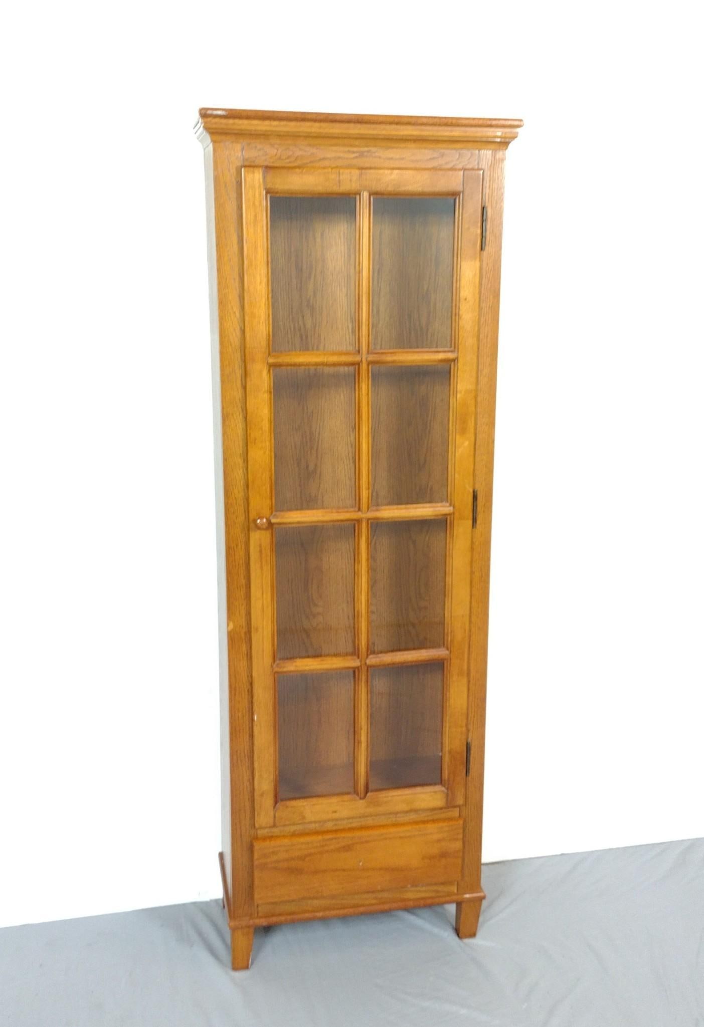 Glass Door Cabinet: NOT ELIGIBLE FOR IN-HOUSE SHIPPING. 22" wide X 11" deep X 64" high. Missing shelves.