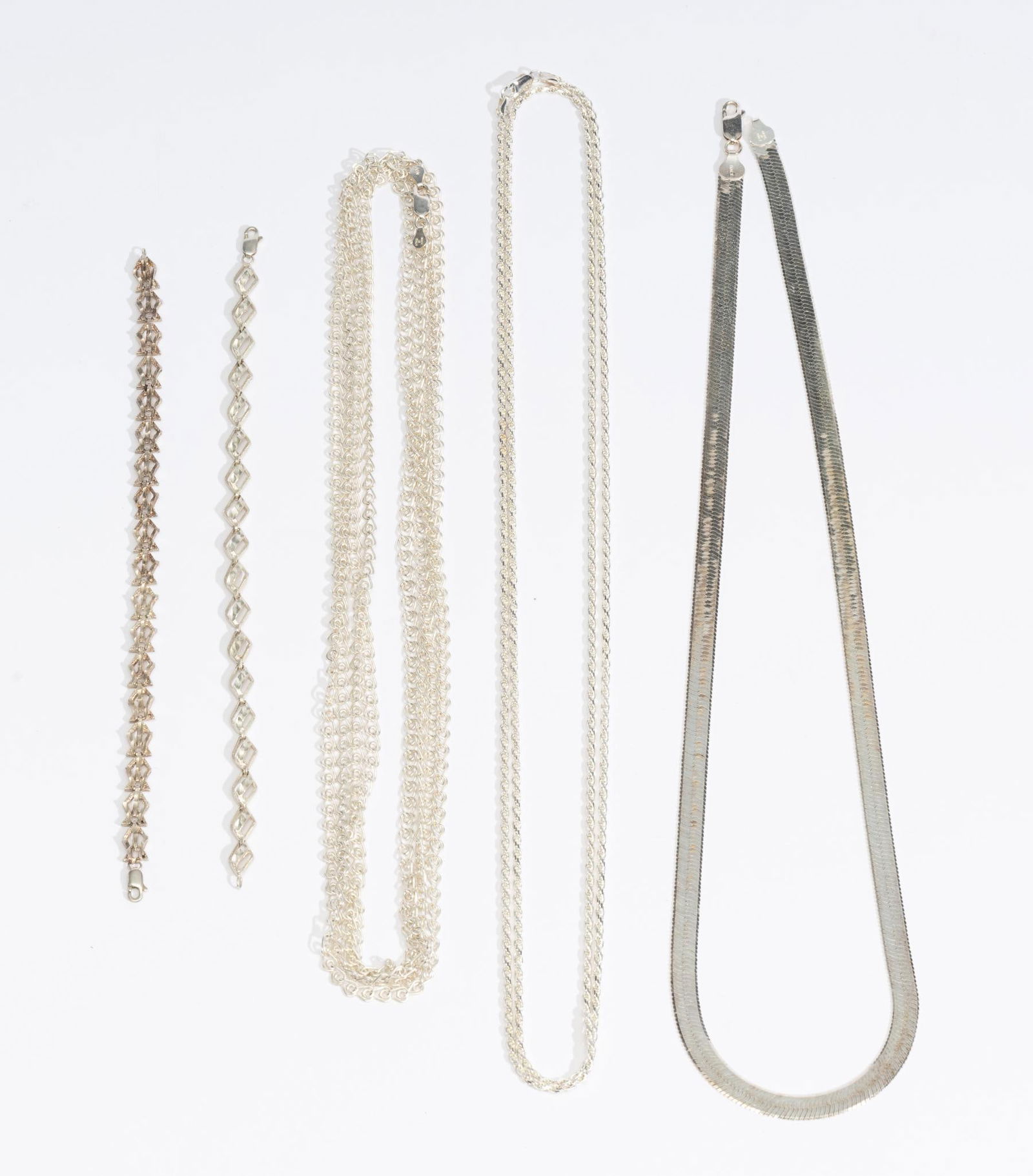 3 Sterling Silver Chain Necklaces and 2 Bracelets: 24" Milor herringbone chain necklace, 80" chain necklace with wire-formed links, 48" rope chain necklace, (2) chain bracelets with custom links. Total weight of 3.0 troy ounces. No damage noted, no be