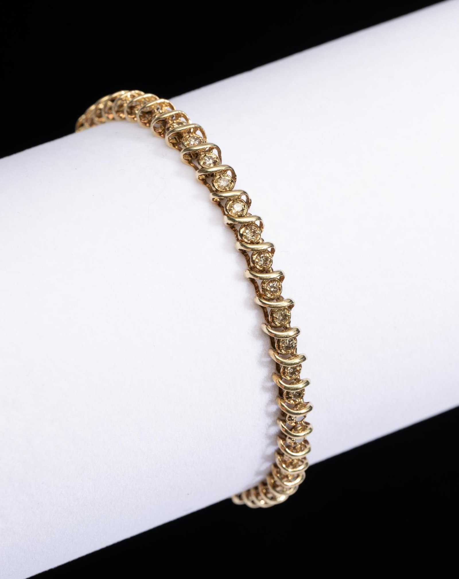 10K Yellow Gold & 1.5 CTW Diamond Tennis Bracelet: Marked 10k yellow gold tennis bracelet set with forty-eight round cut diamonds. 8" long. 11.6 grams.