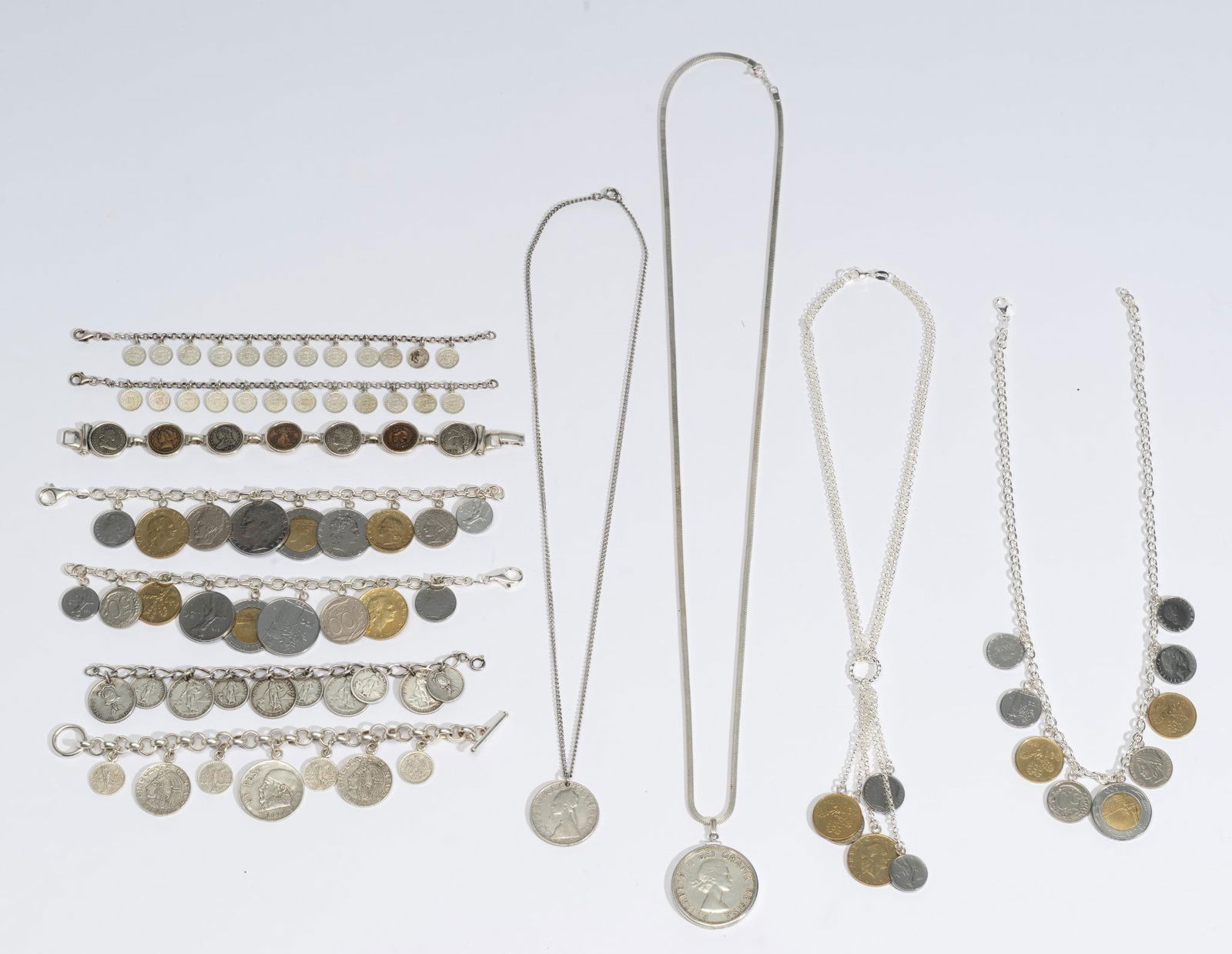 Sterling Silver Chain Necklace and Silver Coin Charm Bracelets: 32" serpentine chain with Canada silver dollar, 24" non-silver chain necklace with silver 500 lira coin, (4) sterling chain bracelets with mostly non-authentic silver coins, (3) sterling silver bracel