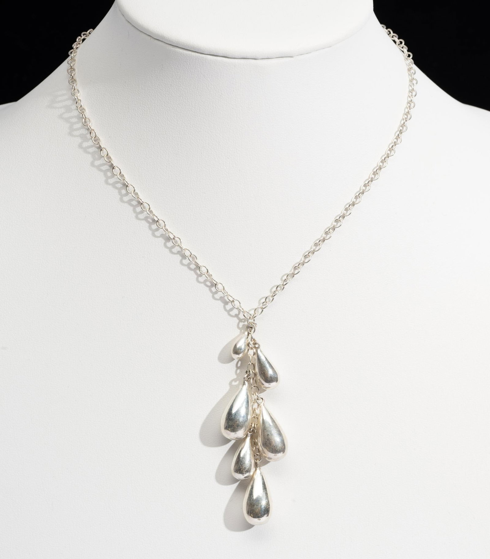 Sterling Silver Necklace: A cable chain necklace with a pendant of six teardrops in cascading sizes. 18" adjustable and with weight of 0.5 troy ounces.