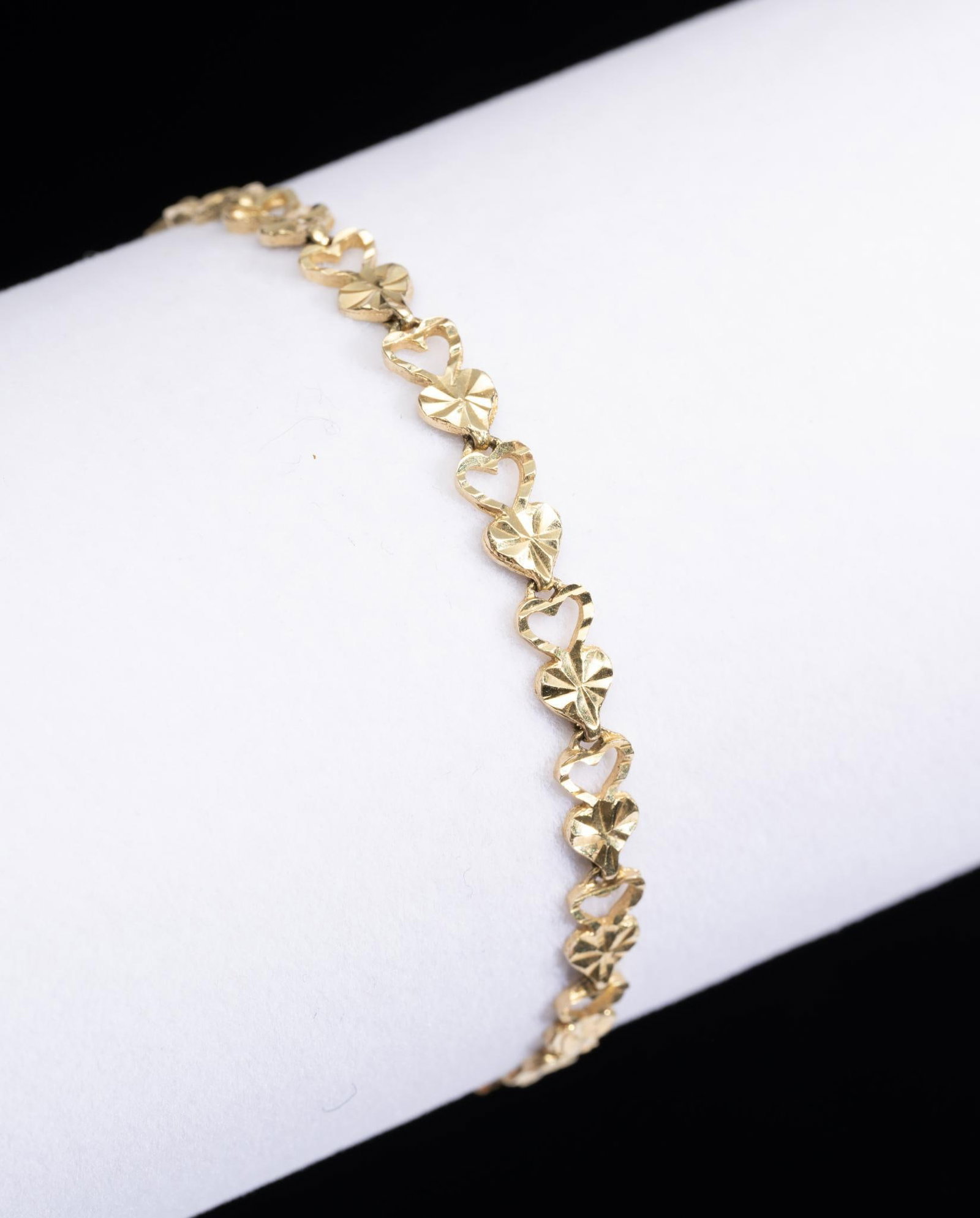 14K Gold Bracelet: A custom design "hearts" link chain with length of 6.5" and weight of 4.2 grams marked 14k.