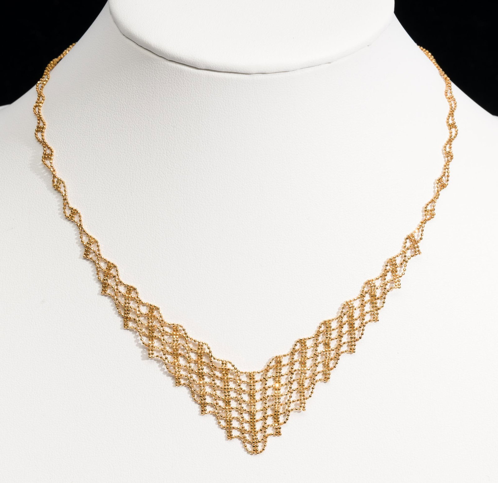 10K Gold Necklace: A necklace of delicate lattice work in 17" length so a bit longer than choker lengths. Total weight of 6.9 grams.