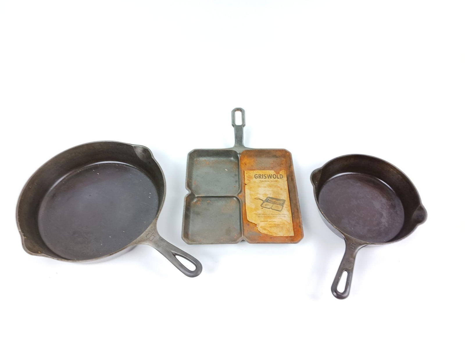 3 Griswold Cast Iron Skillets incl Colonial Breakfast: Colonial Breakfast Skillet number "666". Also includes size 5 and size 8. Colonial Breakfast Skillet with some rusting.