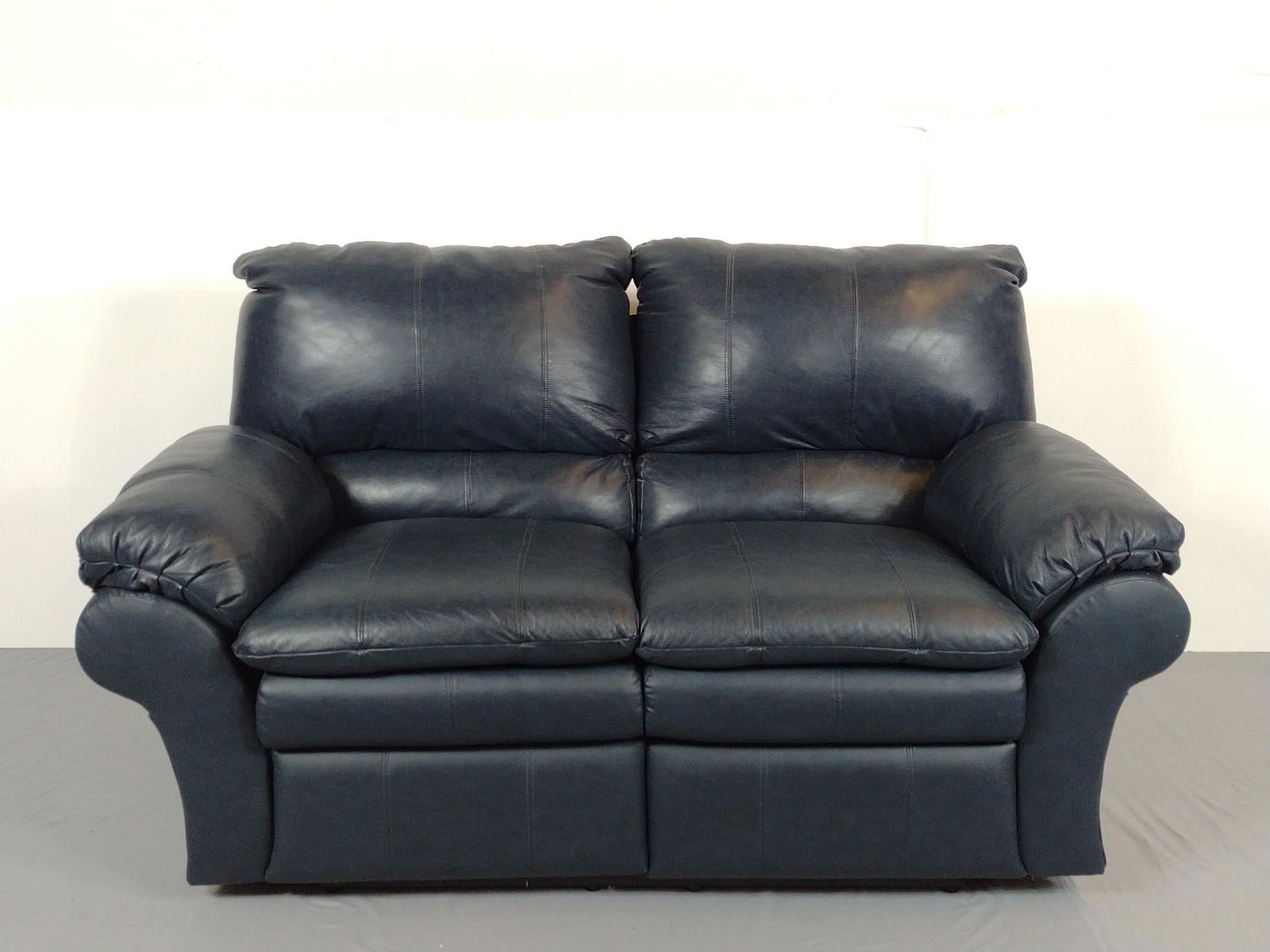 Leather Dual Reclining Loveseat: NOT ELIGIBLE FOR IN-HOUSE SHIPPING. 69" wide X 39" deep X 39" high. Minor wear consistent with age and use.