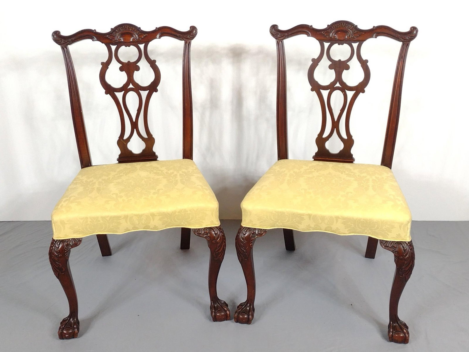 Pair Of Chippendale Side Chairs: NOT ELIGIBLE FOR IN-HOUSE SHIPPING. Ball and claw feet. 23-1/2" wide X 23" deep X 38" high. No manufactures name found. PROVENANCE: Sale of this item to benefit Historic Harrisburg Association.