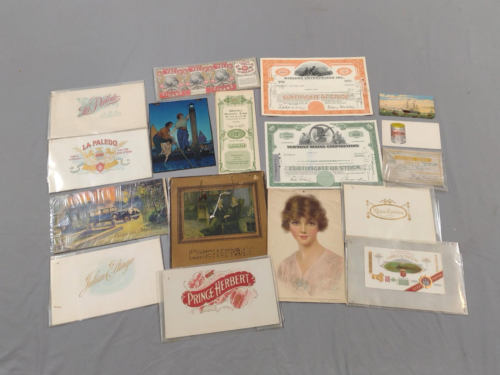 18 Pcs Antique Advertising, Stocks and Bond: Includes 2 stock certificates, Whiteface Mountain Lodge 2nd mortgage bond, Edison Lamp Works of General Electric Co advertising, Luxurious Motoring advertising, and more.