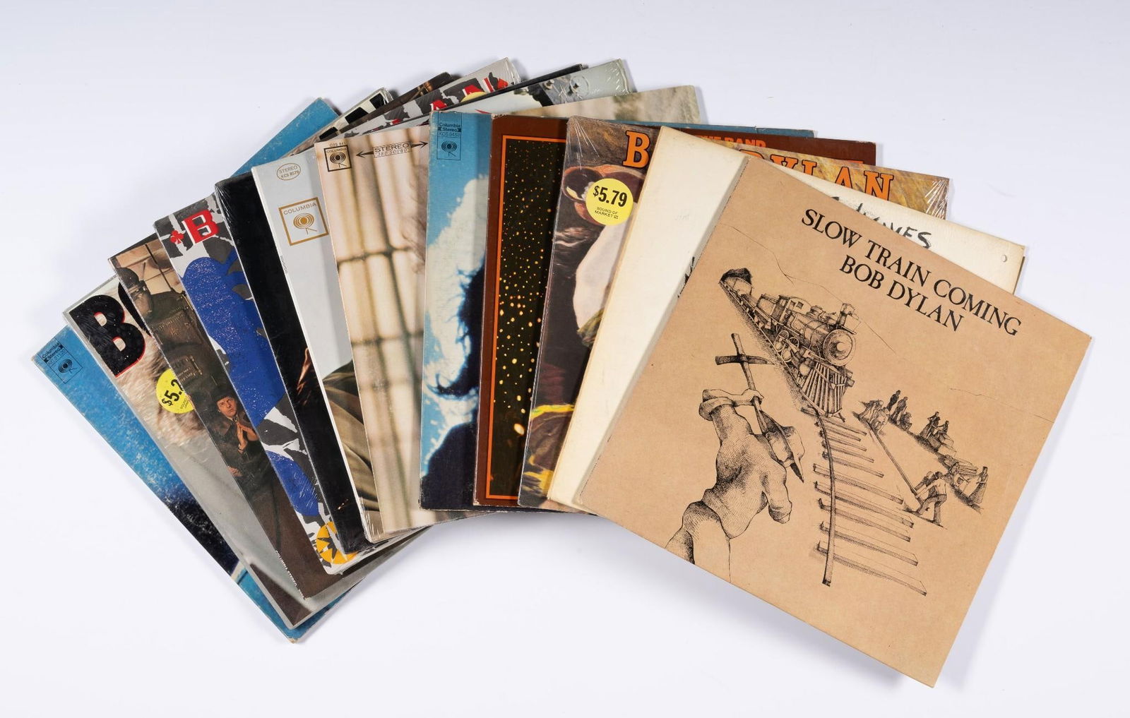 12 Bob Dylan Records: Includes Slow Train Coming, Planet Waves, and more. NOTICE: Records have not been reviewed outside of covers. Some wear and residue to covers due to storage.