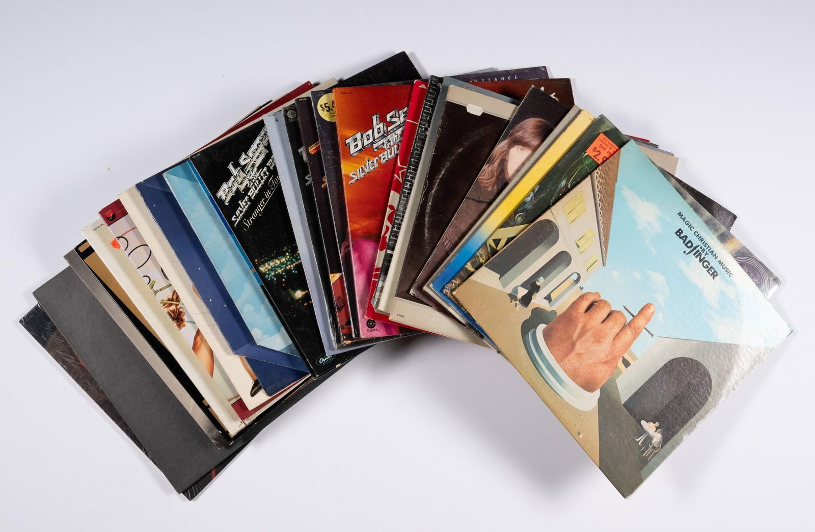 25 Records incl David Bowie and The Who: Also includes Badfinger, Areosmith, and more. NOTICE: Records have not been reviewed outside of covers. Some water damage and residue to covers due to storage.