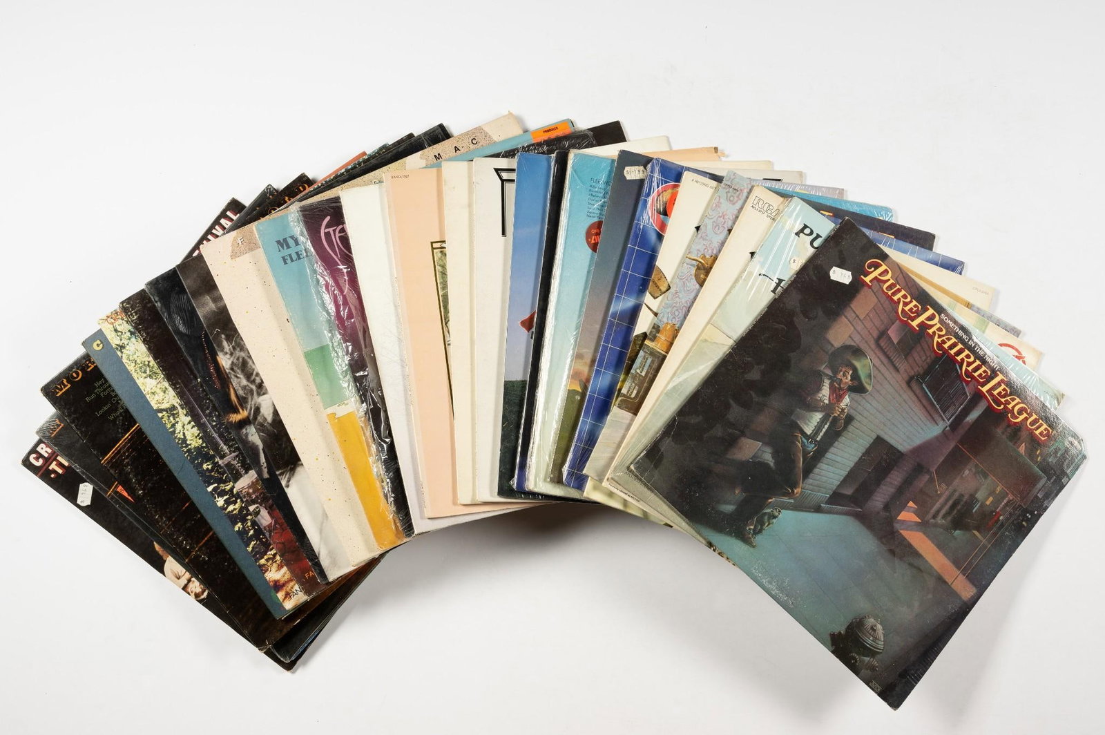 26 Records incl CCR: Includes Creedence Clearwater Revival, Fleetwood Mac (Band and solo work), and Pure Prairie League. NOTICE: Records have not been reviewed outside of covers. Some wear and residue to covers due to sto