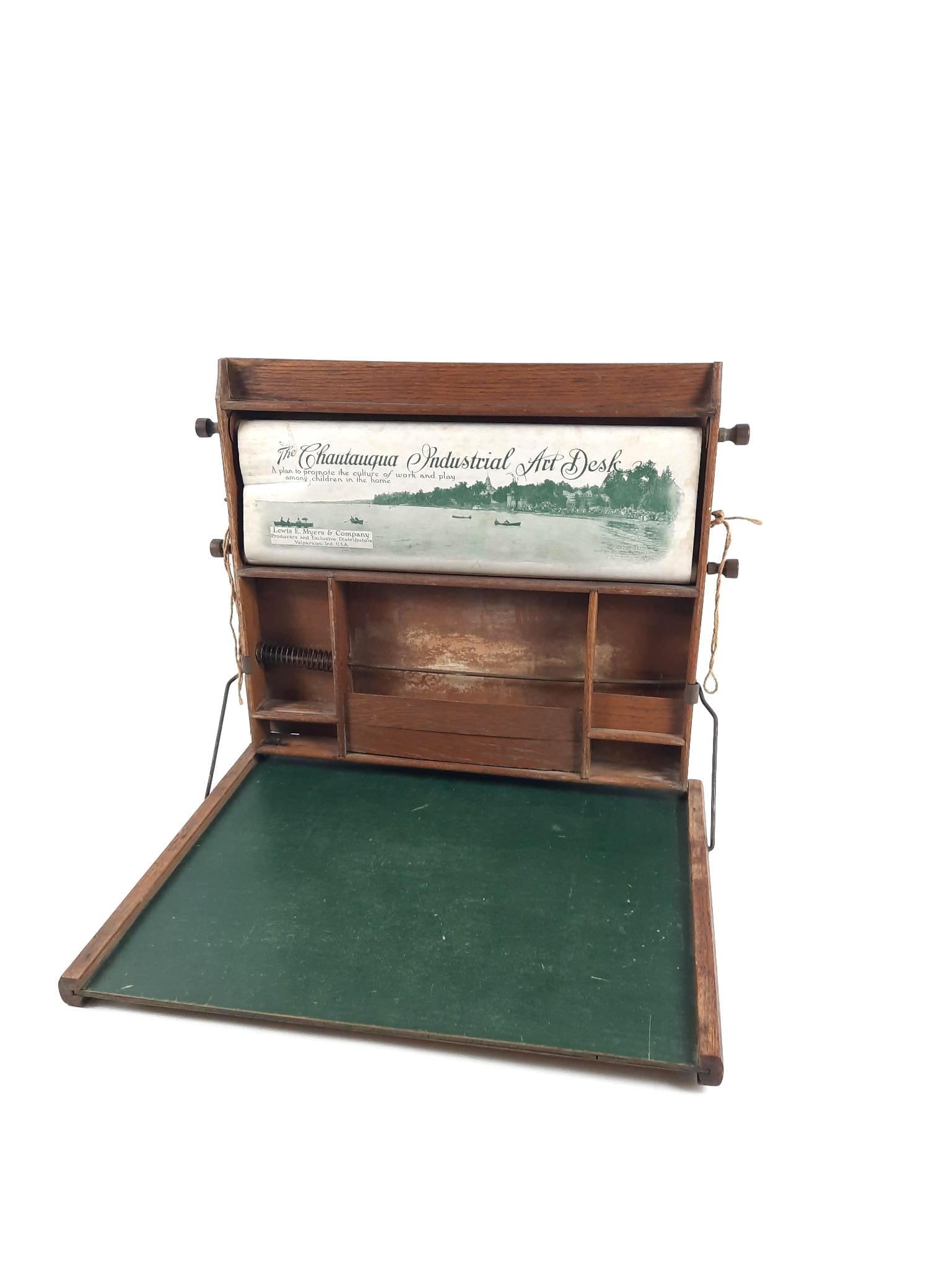 Antique Chautauqua Industrial Art Desk: NOT ELIGIBLE FOR IN-HOUSE SHIPPING. Losses to the wood. Rips to scroll at top. Closed 22" wide x 25-1/4" high.