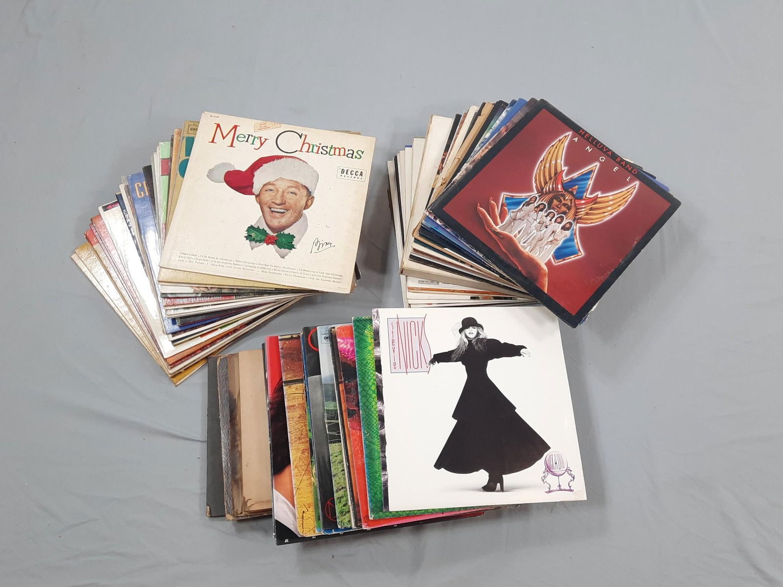 Approximately 75 Records incl Stevie Nicks: NOT ELIGIBLE FOR IN-HOUSE SHIPPING. Also includes Alice Cooper, Bruce Springsteen, and more. Various conditions. Record covers show general wear, some water damage and have a cat odor.