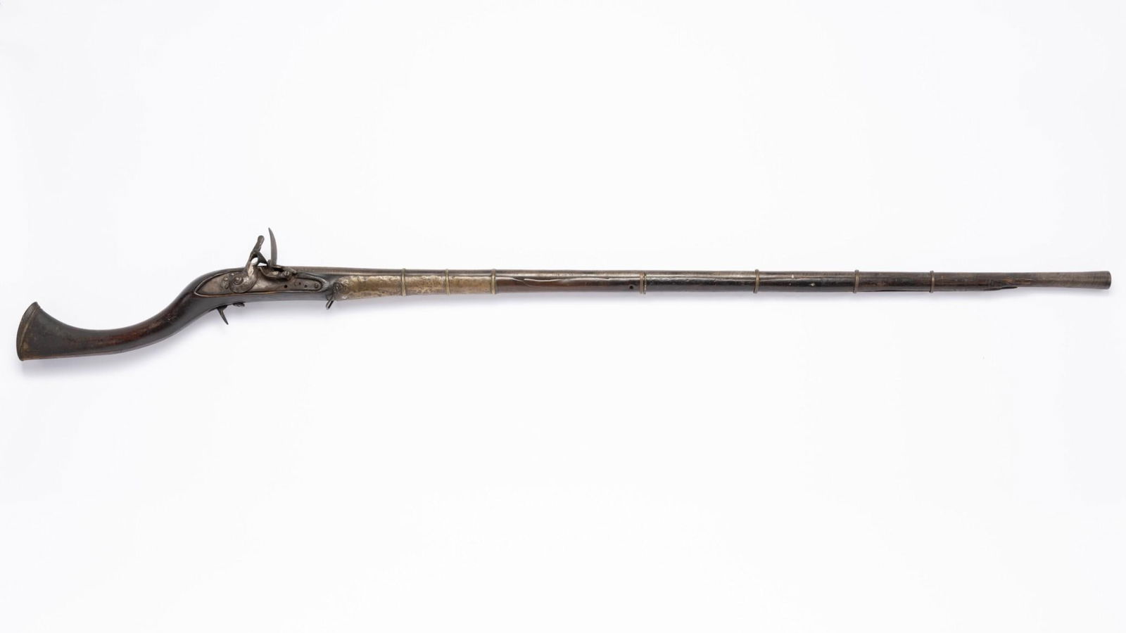 Old Ottoman/North African Flint Long Gun, About .52 Caliber: Serial Number: NSN Design: This antique flint long gun has a 46" twist steel barrel that appears to be about .52 caliber smoothbore. This item is of value as a decorator relic only.. The large, crude