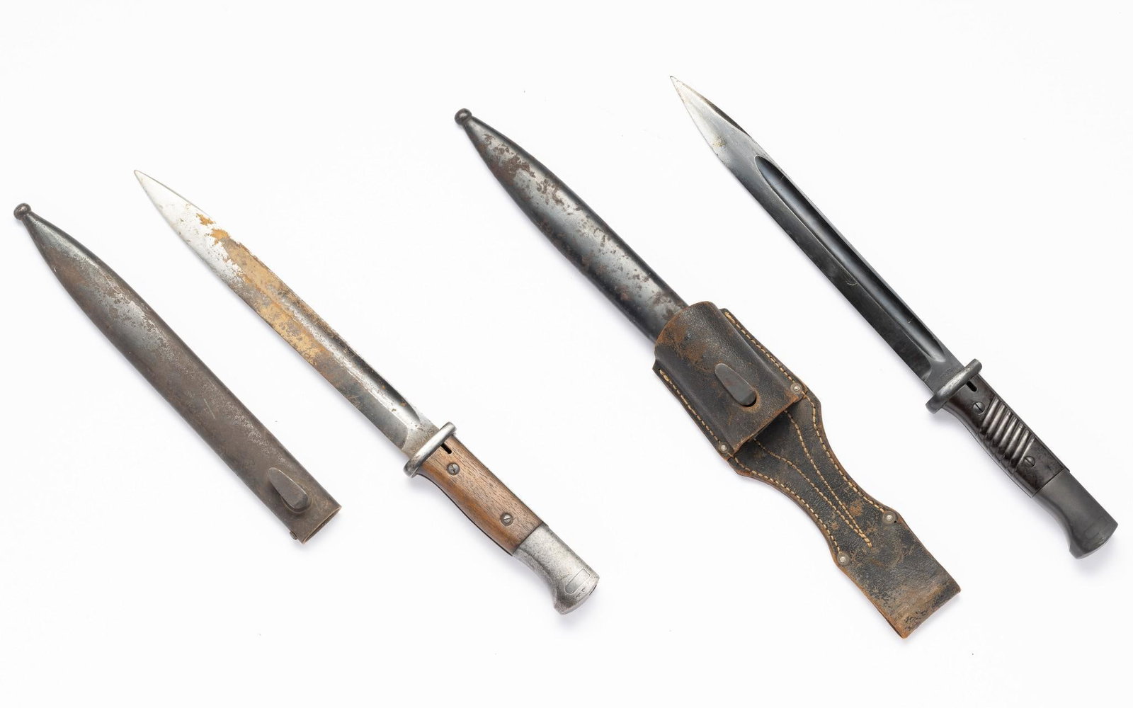 2 Bayonets w/ Scabbards: One marked 4528 on blade. Other marked 194C on blade. Overall 15-7/8" to 16" long. Rusting consistent with age.