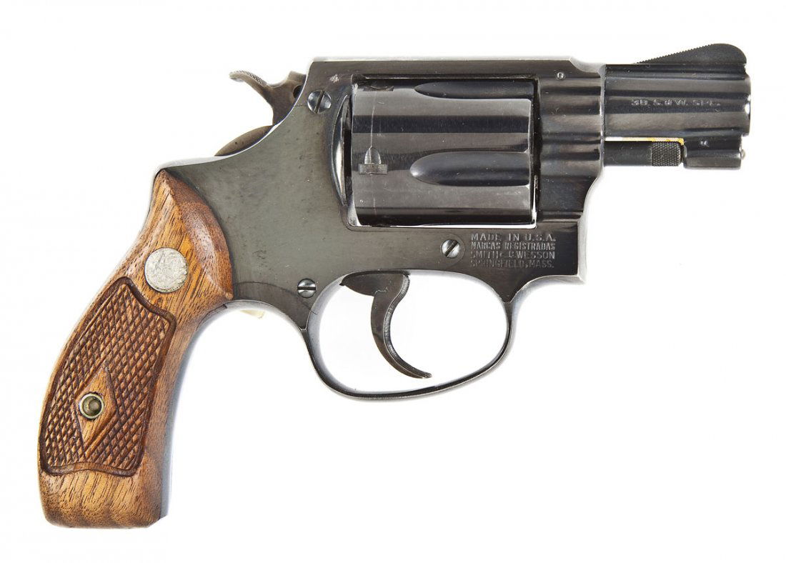 Smith & Wesson Model 36 Revolver - .38 Cal.: SERIAL #: 65879 DATE OF MANF: Circa 1955 DESIGN: Double action with swing out 5-shot cylinder. 1-7/8” barrel. MATERIAL/FINISH COMPOSITION: Blued steel. Case hardened hammer and trigger. Checkered wo