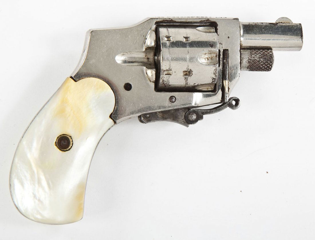 Baby Hammerless Revolver - .22 Short: SERIAL #: None. DESIGN: Six-shot removable cylinder. 1-1/4" barrel. MATERIAL/FINISH COMPOSITION: Nickel plated steel. Mother of pearl grip panels. FEATURES: Blade front sight. Folding trigger. CONDITI