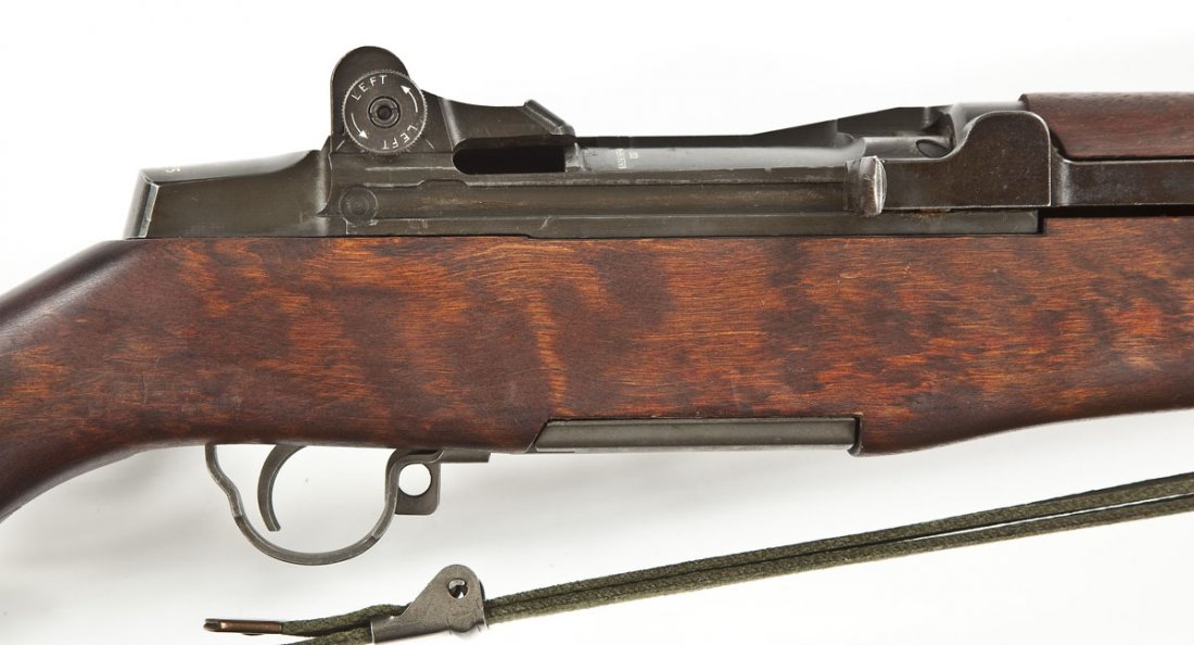 Springfield Armory M-1 Garand Rifle - .30-06 Cal.: SERIAL #: 5459535 DESIGN: Bolt action with internal magazine. 24" barrel. MATERIAL/FINISH COMPOSITION: Blued steel. Military wood stock. FEATURES: Hooded blade front sight. Rear peep sight. Checkered 