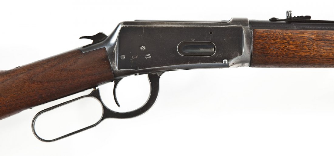 Winchester Model 94 Rifle - .30 WCF Cal.: SERIAL #: 1628846 DATE OF MANF: 1950 DESIGN: Lever action with tubular magazine. 20" barrel. MATERIAL/FINISH COMPOSITION: Blued steel. Wood straight stock and forearm. FEATURES: Raised blade front sig