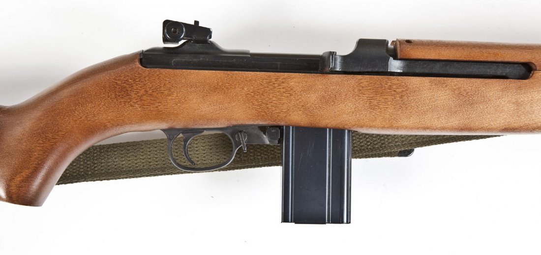 Iver Johnson M-1 D-Day Comm. Carbine - .30 Cal.: SERIAL #: 09800 DATE OF MANF: 1980 DESIGN: Semi-automatic with detachable magazine. 18" barrel. MATERIAL/FINISH COMPOSITION: Blued steel. Wood military style stock. FEATURES: Blade front sight. Rear a