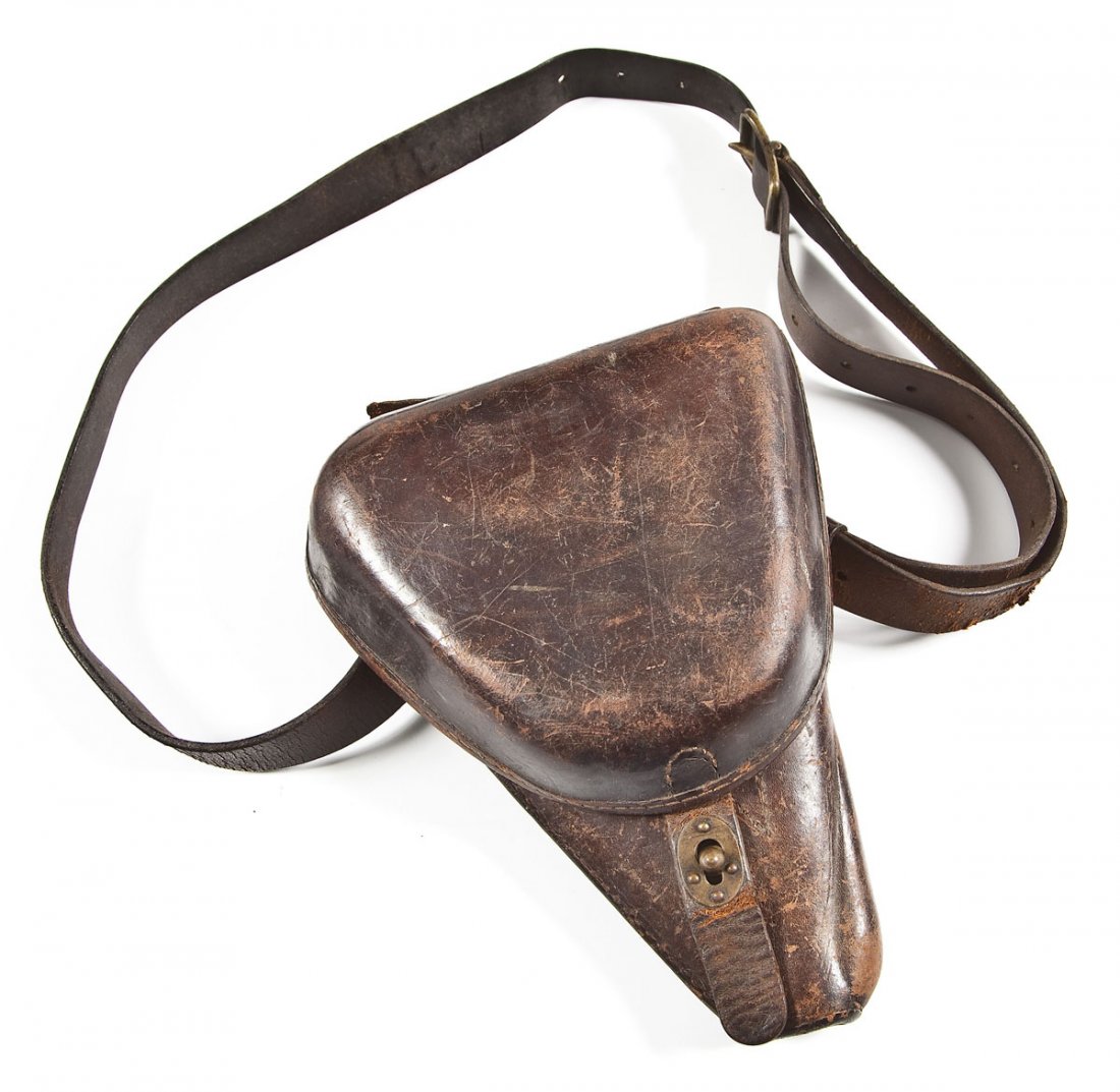 WWII Era Japanese Type 14 Leather Holster: DESCRIPTION: World War II era Japanese leather pistol holster designed for the type 14 Nambu pistol. Includes shoulder strap and an 8mm Nambu magazine. MEASUREMENTS: 9-1/2" x 7-1/2" x 2-1/2". CONDITIO