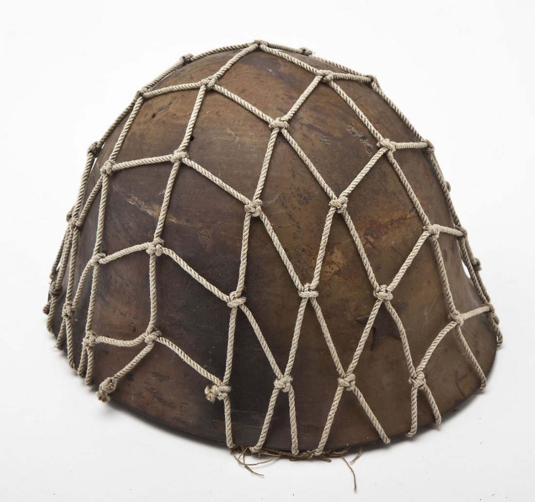 WWII Imperial Japanese Helmet: DESCRIPTION: World War II Imperial Japanese helmet has brown finish and five pointed star. Covered in tan mesh. Retains the head liner and chin strap. MEASUREMENTS: 11" x 9-1/4" x 6-1/4". CONDITION: V