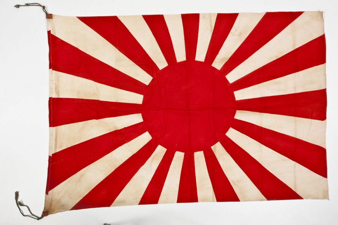 Japanese Rising Sun Flag: DESCRIPTION: World War II era Japanese rising sun cloth flag with reinforced string loop ends. MEASUREMENTS: 41" x 60". CONDITION: Very Good. Sporadic discoloration to white fields. ESTIMATE: $250 - $