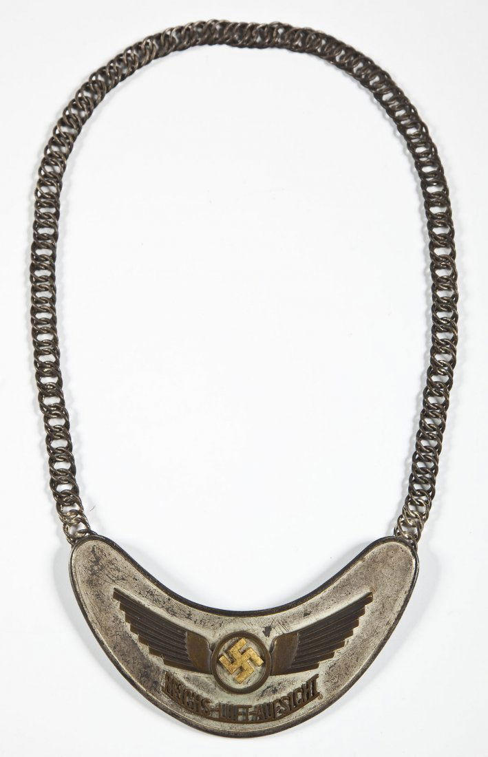 Nazi Air Traffic Controller's Gorget: DESCRIPTION: Nazi air traffic controller's gorget with link chain. "REICHS-LUFT-AUFSICHT" label under Nazi symbol. Clip on rear marked "FLUGZEUGFUHRER.SCHULE FURTH". MEASUREMENTS: 6-1/4" x 3-1/2". CON